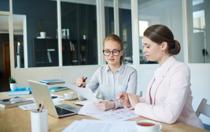 Two clever students reading task on paper before start to carry it out