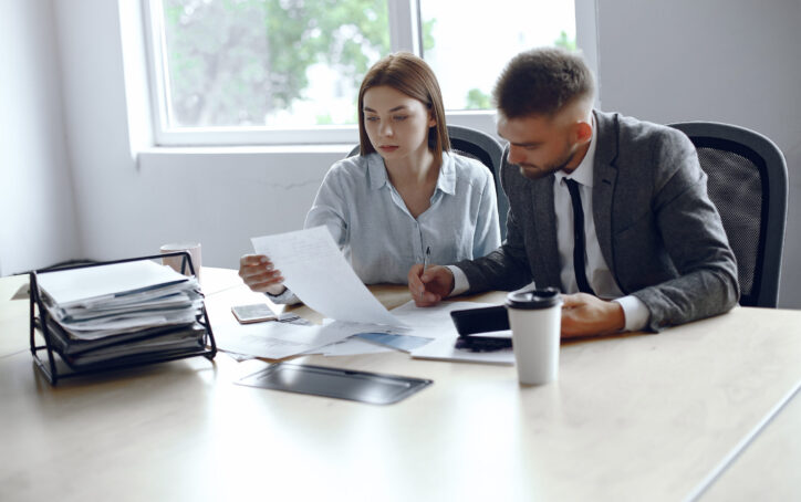 Colleagues drink coffee.Business partners at a business meeting.Man and woman sitting at the table