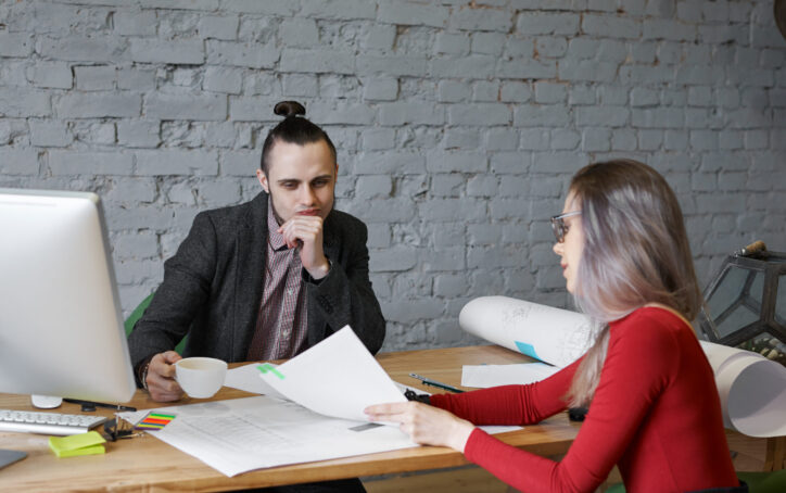 Economist woman show boss of architect company balance of money for building new shop. Thinking emotion on man face. Talented female student show her CV to human resource director.